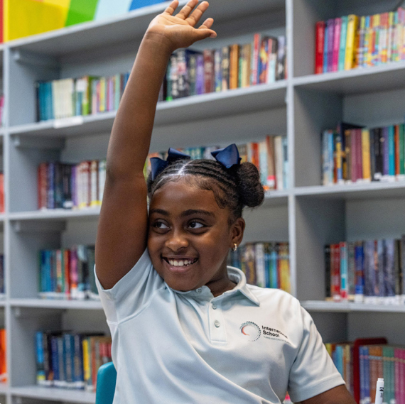 Student at the International School Turks and Caicos Islands expressing ideas clearly and listening respectfully.