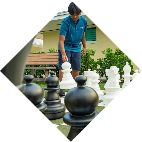 Student participating in outdoor chess as an extracurricular activity at the International School Turks and Caicos Islands.