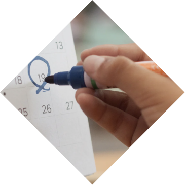 Hand marking a date on the academic calendar at International School Turks and Caicos Islands